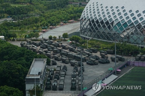 홍콩 접경 지역인 중국 선전의 선전만 스타디움 밖에 16일 무장경찰 소속의 장갑차와 병력 수송 트럭 등이 정렬해 있다. 사진=AP연합뉴스